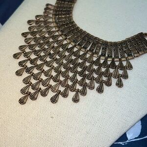 Copper-colored statement bohemian necklace with a bib design tear drop